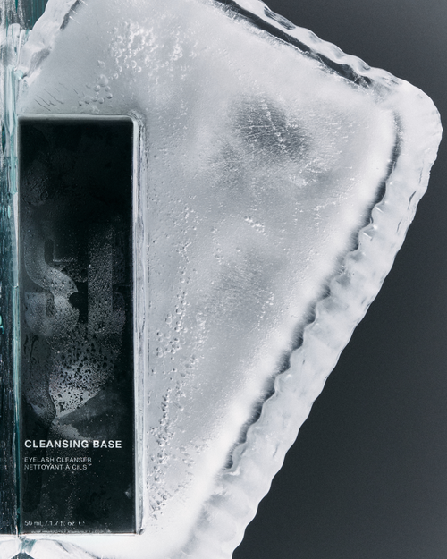 Lash extensions cleansing base resting on an ice block.
