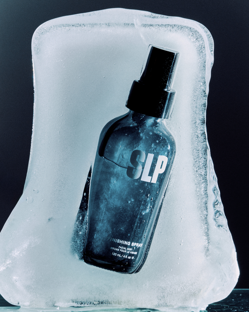 A Finishing Spray bottle on a large ice block for skin and eyelash extensions