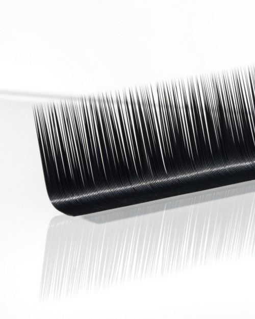 A strip of Flat lash extensions on a white background.
