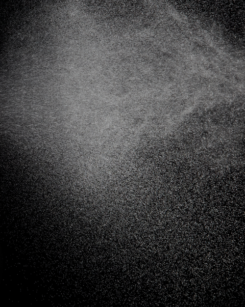 Clear mist over a black background used for skin and eyelash extensions