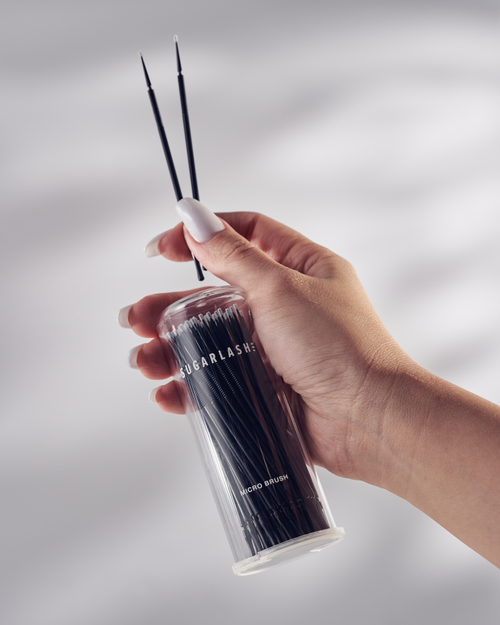 Model holding a package of Micro Brushes for eyelash extensions