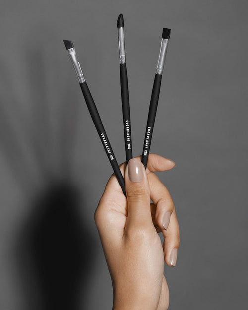 Model holding three Silicone Brushes for lash lifts and eyebrow lamination.
