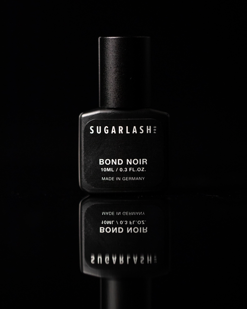 A 10mL bottle of Bond Noir lash extension glue with it's reflection showing underneath of the bottle.