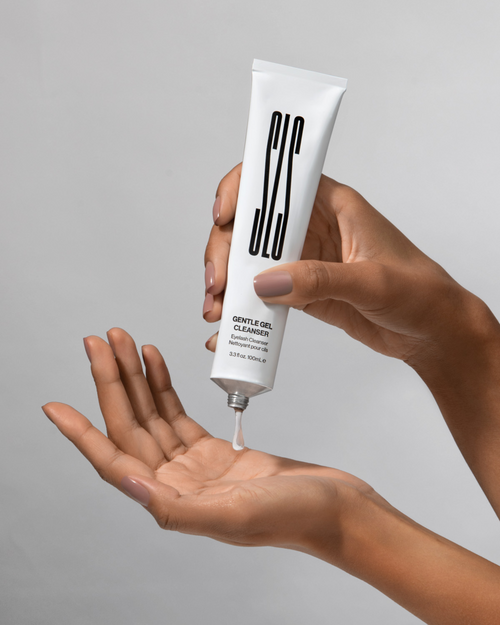 A model squeezing Gentle Gel Cleanser on to their other hand for eyelash extensions.